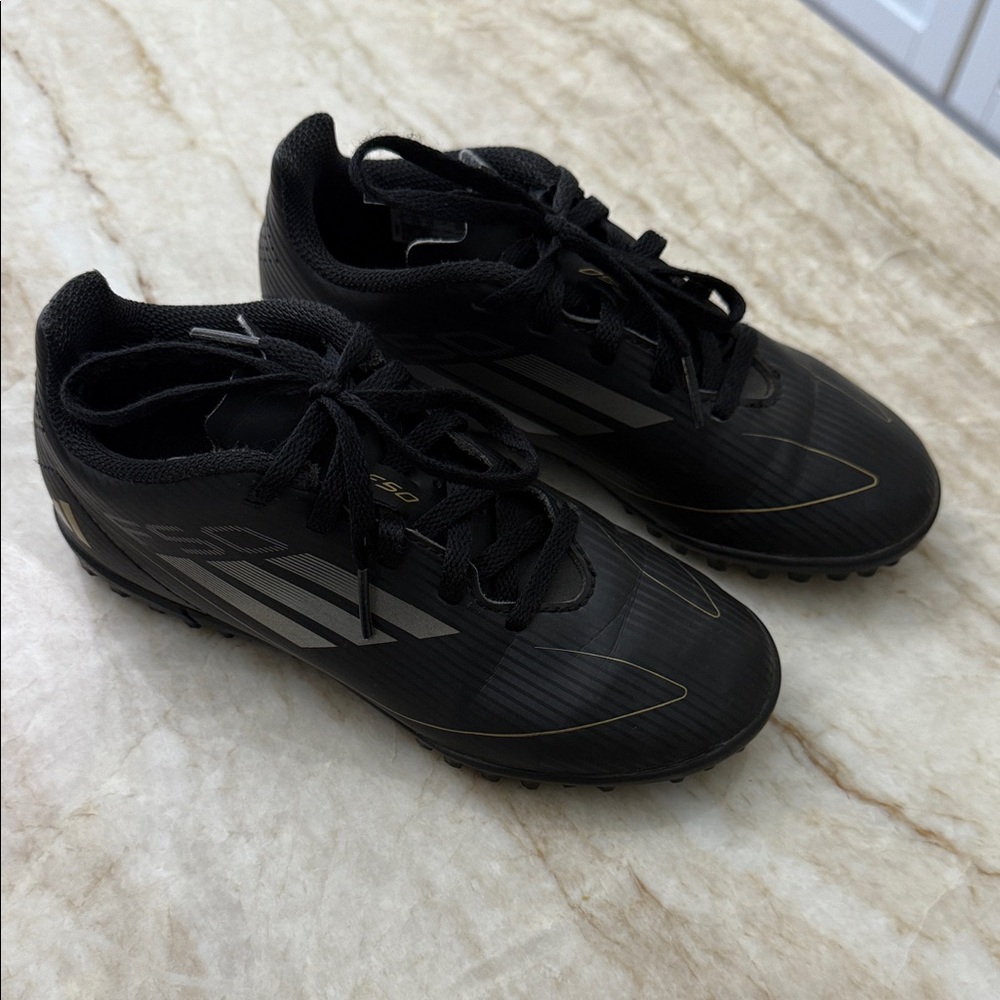 Adidas Boys Black and Gold indoor soccer cleats Shoes